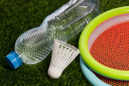 Rackets and a ball on the stadium grass