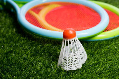 Red shuttlecock on the grass of the stadium, badmintonの写真素材