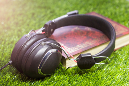 Big black headphones on the grass in the garden, relaxation in natureの写真素材