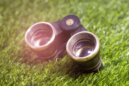 Retro theatrical binoculars on the grass in the parkの写真素材