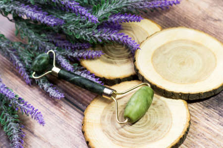 Jade stone facial massager and lavender bouquetの写真素材
