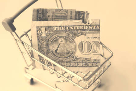 Dollars in a shopping cart. Black and white photo.の写真素材