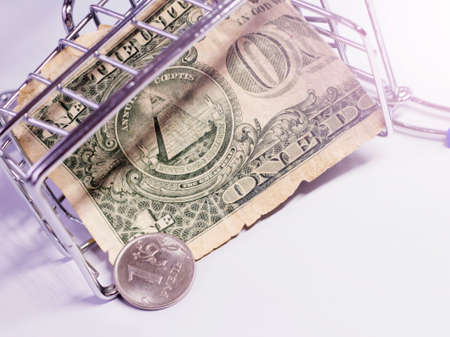 Dollars in a metal basket on a white background. Business conceptの写真素材