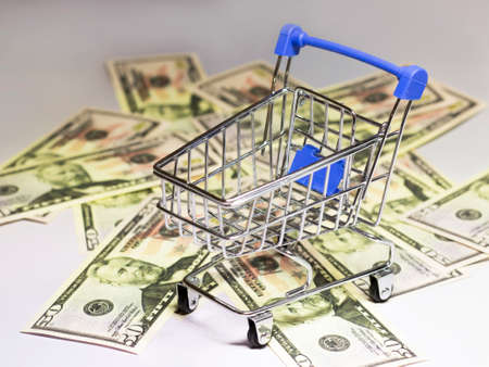 An empty shopping cart and moneyの写真素材