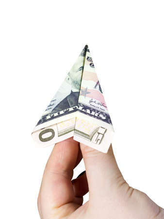 A plane made of a $50 bill in a woman's handの写真素材