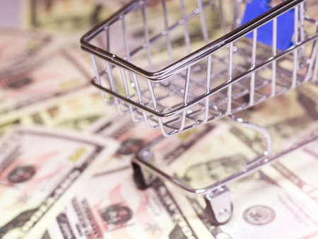 An empty shopping cart and moneyの写真素材
