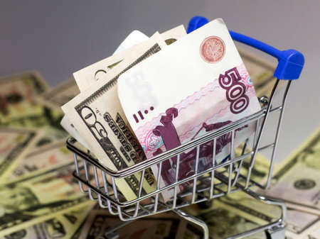 dollars and rubles bills in the shopping cartの写真素材