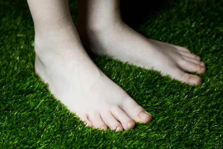 Children's feet on the grass, summer vacation