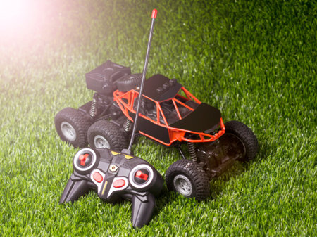 Toy car and joystick on the grass