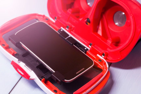 Close-up of a smartphone in a red case on a white background