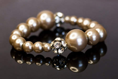 a bracelet on a black mirror surface