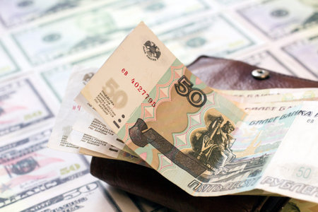 Money in the wallet on the background of dollar bills. Selective focus.