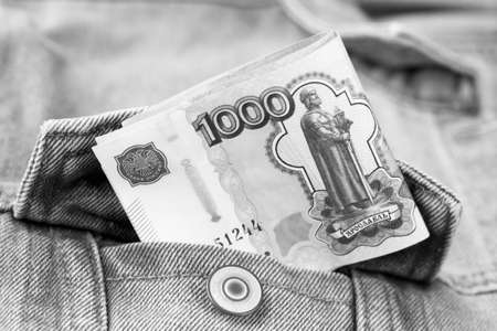 Money in the pocket of jeans, black and white photo. High quality photoの写真素材
