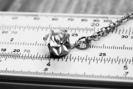 Jewelry and accessories: pendant and ruler. Black and white photo.の写真素材