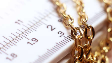 Gold chain on a ruler in a pawnshop, macroの写真素材