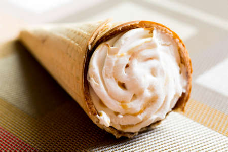 Fruit vanilla ice cream in a cone is very closeの写真素材