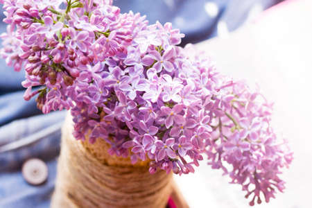 Bouquet of lilac in a vase on a light backgroundの写真素材