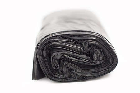 A roll of a garbage bag in black on a white backgroundの写真素材