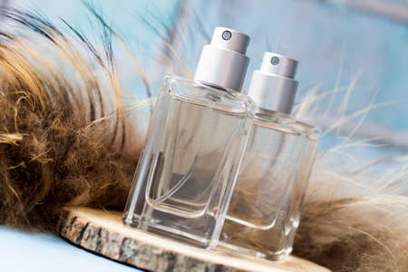 Transparent perfume bottles and fur so closeの写真素材