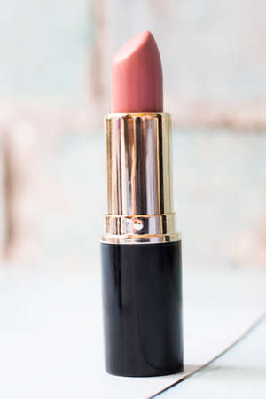 Pink lipstick in a black case is very closeの写真素材