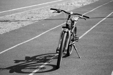 Mountain speed bike at the stadium and shadow on the roadの写真素材