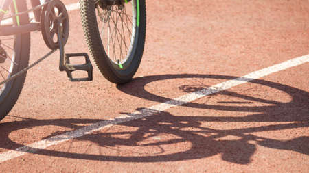 Mountain speed bike at the stadium and shadow on the roadの写真素材