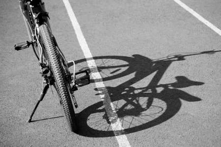 Mountain speed bike at the stadium and shadow on the roadの写真素材