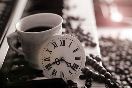 A clock with Roman numerals and a piano, a cup of coffee, retroの写真素材