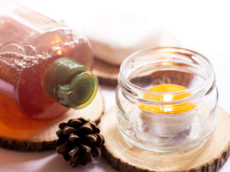 Spa still life with candles and aromatherapy oil on white backgroundの写真素材