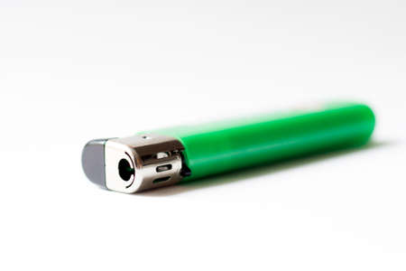 Green lighter on a white background. Close-up. Isolate.の写真素材