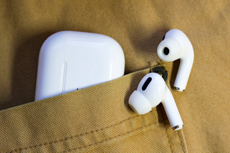 White wireless headphones on Men's jacketの写真素材