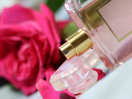Perfume bottle with pink rose petals, close-upの写真素材