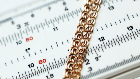 Golden chain on a ruler, close-up, macro photo.の写真素材