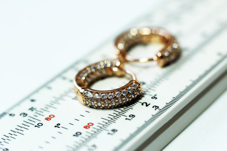 Wedding rings on a white background with a ruler and scale