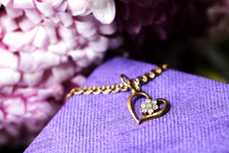 jewelry with a heart on a purple background, close upの写真素材