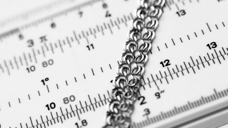 Close up of a metal chain on a ruler. Selective focus.の写真素材