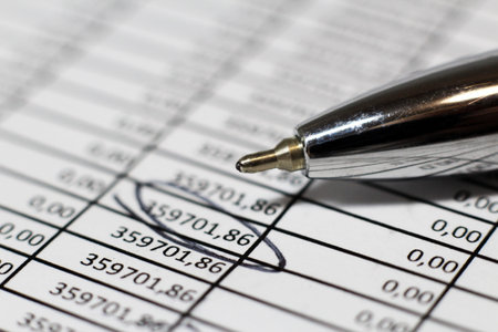 Close-up of a ballpoint pen on a financial report.