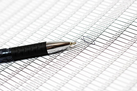 financial chart with pen on white background.