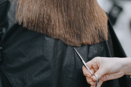 Womens haircut at home. Hairdresser cuts a girl at home.