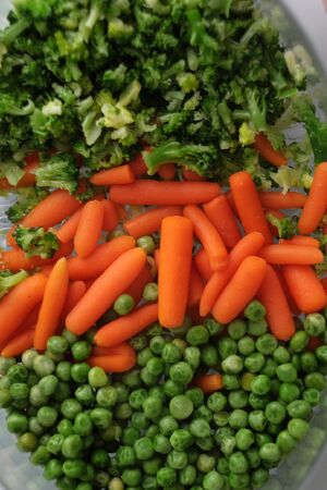 Fresh vegetables cooked in a double boiler. Green peas, carrots, broccoliの写真素材