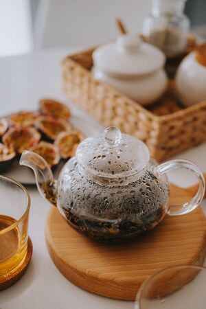 Teapot with tea on a wooden stand. Beautiful breakfastの写真素材