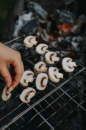 Cooking champignon mushrooms on the grill. Outdoor picnicの写真素材