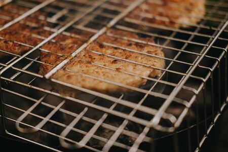 The process of preparing meat cutlets for grilled burgers. Picnic in the fresh airの写真素材