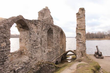 Wall of a ruined castle in Koknese. Medieval fortress at the shore of the Daugava river. Rays of the sun that falls on the gothic remains.の写真素材