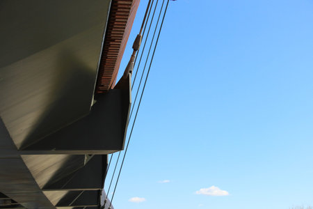 Suspension bridge from below. Bridge construction elements.