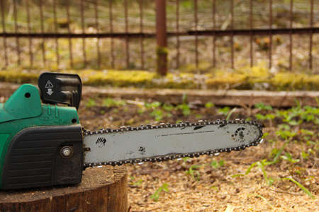 Chainsaw on a tree stump. Used saw blade.の写真素材