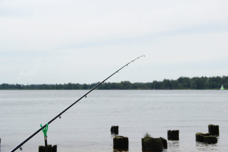 Fishing pole in use at the seashore. Fishing time alone.