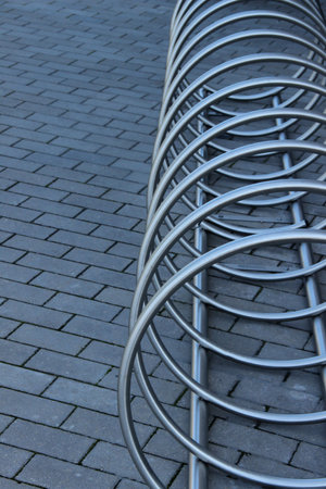 Stainless steel bicycle parking rack. Modern bicycle parking stand makes an abstract background.の写真素材
