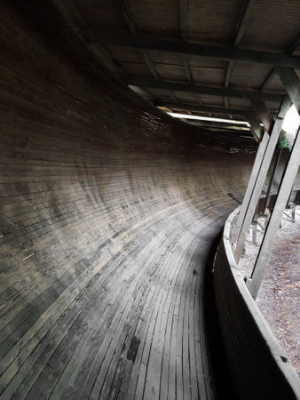 Abandoned wooden bobsleigh track. Sleigh tunnel made a curve. Obsolete sports track.の写真素材