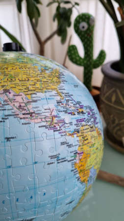 World globe made of puzzle pieces. Home decor with educational context. World map with oceans and lands.の写真素材